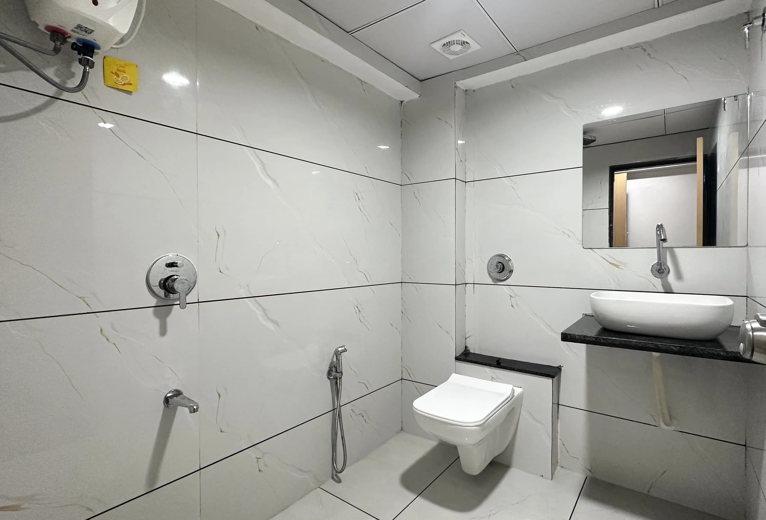 Luxora Boys PG 1 clean attached washroom with modern geyser and fittings